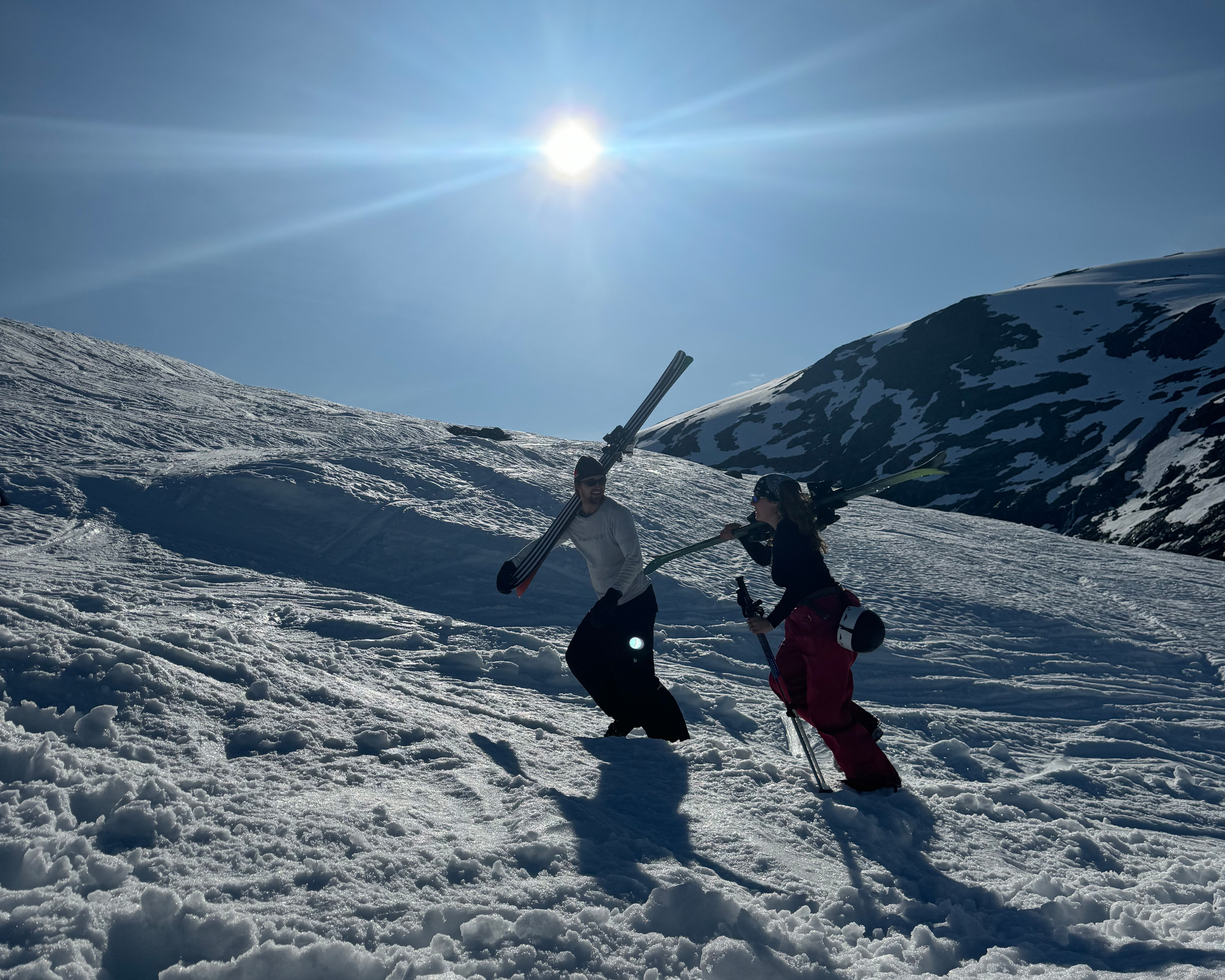 To people walking in the snow with skis